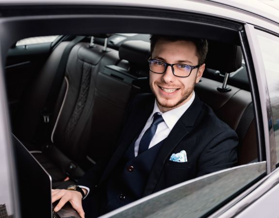 Corporate person in a black car