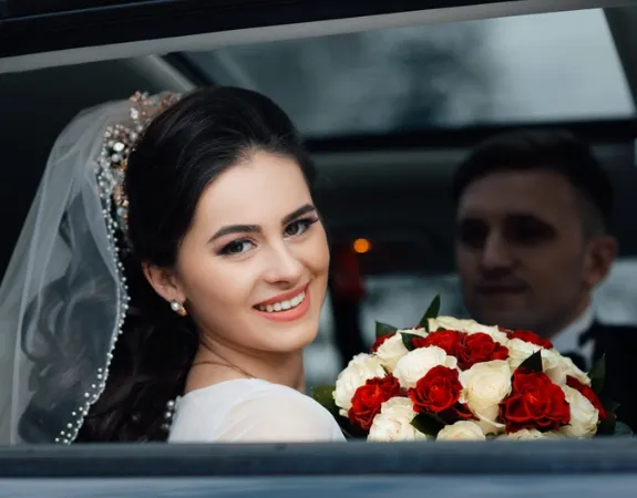 Happy wedding couple in luxury limo.